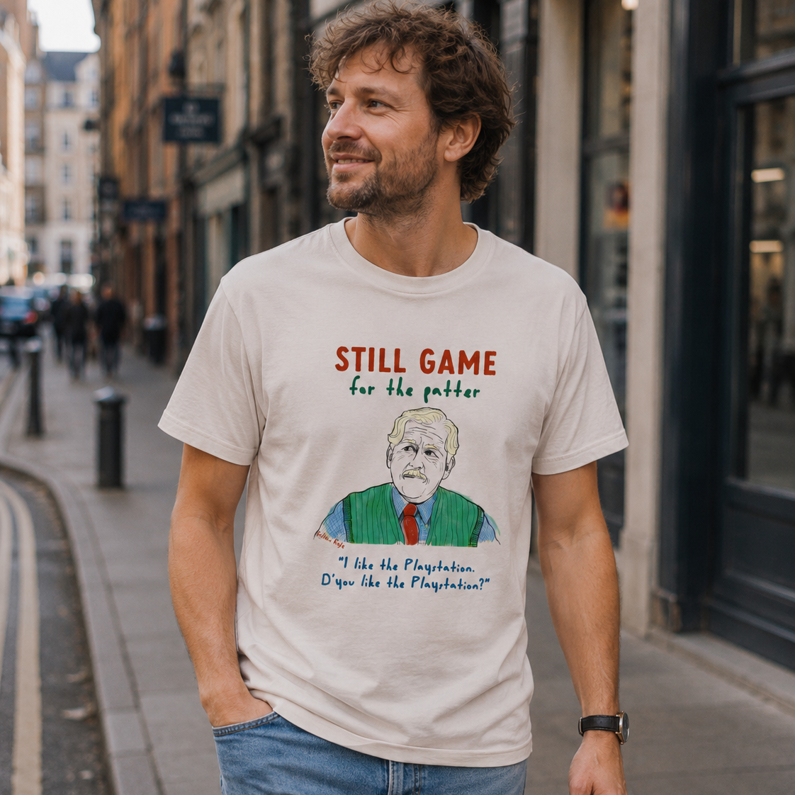 Man wearing a t-shirt with a graphic and text on a city street