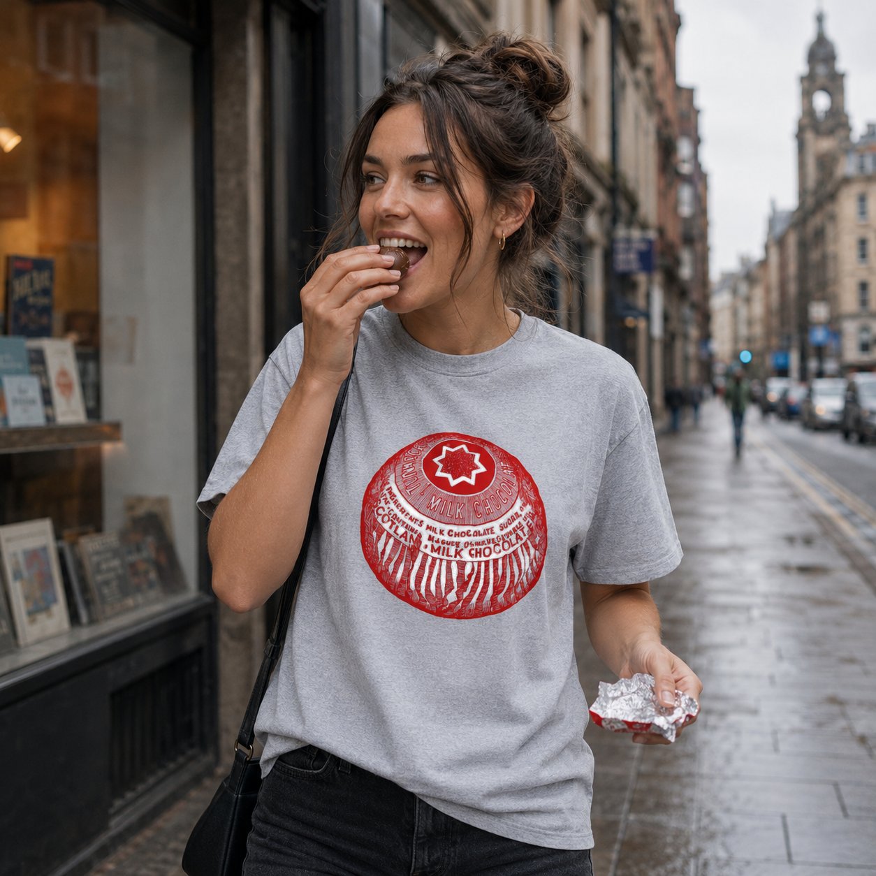 Woman wearing a gray t-shirt with a red logo on a city street